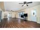 Spacious living room with hardwood floors, ceiling fans, a large window, and neutral paint at 2520 Cross Springs Dr, Cumming, GA 30041