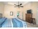 This main bedroom features neutral walls, ceiling fan, and a wooden dresser with TV at 2520 Cross Springs Dr, Cumming, GA 30041