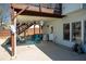 Covered patio area with a ceiling fan, seating, and a grill, perfect for outdoor entertaining at 2520 Cross Springs Dr, Cumming, GA 30041