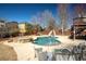 Sparkling pool with slide and hot tub, surrounded by a concrete patio and a well-manicured yard at 2520 Cross Springs Dr, Cumming, GA 30041