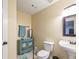 Charming powder room with a blue vanity, white toilet, and neutral walls at 2520 Cross Springs Dr, Cumming, GA 30041