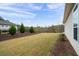 Well-maintained backyard featuring a lush lawn, manicured landscaping, and a view of the surrounding trees at 4902 Pleasantry Way, Acworth, GA 30101