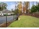 Community dog park surrounded by a black chain-link fence with mature trees and landscaping at 4902 Pleasantry Way, Acworth, GA 30101