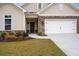 Home's exterior showcasing stone details, a two-car garage, and well-maintained lawn at 4902 Pleasantry Way, Acworth, GA 30101