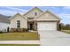 Beautiful home featuring stone accents, a well-manicured lawn, and a two-car garage at 4902 Pleasantry Way, Acworth, GA 30101