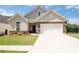 Charming single-Gathering home featuring stone accents, a two-car garage, and a beautifully landscaped front yard at 4902 Pleasantry Way, Acworth, GA 30101
