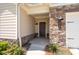 Inviting front entrance with stone accents, a covered porch, and manicured landscaping at 4902 Pleasantry Way, Acworth, GA 30101