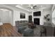 Staged living room showcasing a fireplace, neutral furniture, and tray ceiling at 4902 Pleasantry Way, Acworth, GA 30101