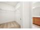 Spacious walk-in closet with wire shelving and neutral carpeting located steps away from the bathroom at 4902 Pleasantry Way, Acworth, GA 30101