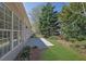 A cozy backyard with a concrete patio and lush green lawn that enhances the home's outdoor living space at 6560 Waveland Dr, Cumming, GA 30040