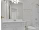Bright bathroom with white vanity, large mirror, and shower-tub combination at 6560 Waveland Dr, Cumming, GA 30040