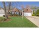 Beautiful brick home with manicured lawn, charming curb appeal, and a convenient two-car garage at 6560 Waveland Dr, Cumming, GA 30040