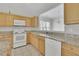 Well-lit kitchen featuring modern appliances and granite countertops at 6560 Waveland Dr, Cumming, GA 30040