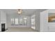 Bright living room featuring a fireplace and large windows at 6560 Waveland Dr, Cumming, GA 30040