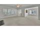 Open living area with neutral carpet and bright natural light at 6560 Waveland Dr, Cumming, GA 30040