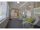 Relaxing sunroom with multiple windows, wicker chairs, and overhead fan at 6560 Waveland Dr, Cumming, GA 30040