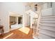 Welcoming foyer with hardwood floors, staircase, and an open view to the living room with glass doors at 1439 Evers Pl, Lawrenceville, GA 30043