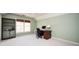 Bright home office featuring built-in bookshelves, a work desk, and natural light from a large window at 1439 Evers Pl, Lawrenceville, GA 30043