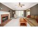 Cozy living room featuring plush seating, a brick fireplace, and natural light from the windows at 1439 Evers Pl, Lawrenceville, GA 30043