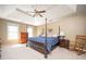 Comfortable main bedroom with tray ceilings, a four poster bed, and cozy furniture at 1439 Evers Pl, Lawrenceville, GA 30043