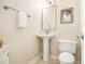 Simple half-bathroom with a pedestal sink, toilet, and neutral wall color at 2050 Federal Rd, Roswell, GA 30075