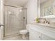 Modern bathroom featuring a glass shower, granite countertop, and white cabinets at 2050 Federal Rd, Roswell, GA 30075