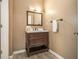 Charming bathroom featuring a dark wood vanity and ample lighting at 2050 Federal Rd, Roswell, GA 30075