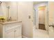 Bright bathroom with white cabinets, granite countertops, and tiled shower at 2050 Federal Rd, Roswell, GA 30075