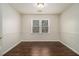 Bedroom with hardwood floors, neutral walls, and a ceiling light at 2050 Federal Rd, Roswell, GA 30075