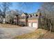 Brick home featuring a two-car garage, manicured lawn, and a classic design in a suburban setting at 2050 Federal Rd, Roswell, GA 30075