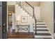 Welcoming foyer featuring hardwood floors, a staircase, and decorative accents that enhance the home's charm at 2050 Federal Rd, Roswell, GA 30075