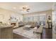 Cozy living room featuring a fireplace, hardwood floors, comfortable seating, and large windows for natural light at 2050 Federal Rd, Roswell, GA 30075