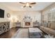 Bright living room featuring a fireplace, hardwood floors, and comfortable seating for relaxation and entertainment at 2050 Federal Rd, Roswell, GA 30075