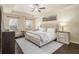 Serene main bedroom featuring a tray ceiling, ceiling fan, and neutral decor at 2050 Federal Rd, Roswell, GA 30075