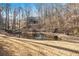 View of the pond with fountain surrounded by grass and trees, creating a serene and private backyard oasis at 2050 Federal Rd, Roswell, GA 30075