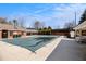 Community pool with a cover, lounge chairs, and building, perfect for neighborhood enjoyment at 2050 Federal Rd, Roswell, GA 30075