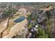 Birds eye view of homes on a golf course with a pond and mature trees surrounding the landscape at 8700 Mount Rushmore Dr, Alpharetta, GA 30022