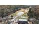 Overhead view of a golf course, clubhouse, and pond, showcasing the community's amenities at 8700 Mount Rushmore Dr, Alpharetta, GA 30022