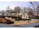 Stunning modern home featuring clean lines, a full-glass facade, and meticulously manicured landscaping on a multi-tiered lot at 14 Lake Forrest Ln, Atlanta, GA 30342