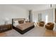 Beautifully designed main bedroom featuring hardwood floors, a seating area, and modern finishes at 14 Lake Forrest Ln, Atlanta, GA 30342