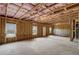An unfinished basement featuring exposed insulation, concrete floors, and natural light at 3870 Ivy Cottage Dr, Snellville, GA 30039