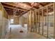 Unfinished basement with exposed wood framing, concrete walls, and ceiling insulation at 3870 Ivy Cottage Dr, Snellville, GA 30039