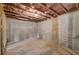 An unfinished basement with concrete walls and floors and pink insulation above at 3870 Ivy Cottage Dr, Snellville, GA 30039