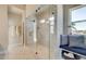Spacious bathroom featuring a walk-in shower with glass enclosure, seat and tiled walls at 3870 Ivy Cottage Dr, Snellville, GA 30039