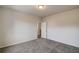 Bedroom with carpeted floors, white trim, neutral walls, and an open door to landing at 3870 Ivy Cottage Dr, Snellville, GA 30039