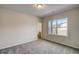 Bright bedroom with carpeted floors and a window view of the outdoors and neutral walls at 3870 Ivy Cottage Dr, Snellville, GA 30039