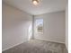 Comfortable bedroom featuring neutral carpet and a window offering natural light at 3870 Ivy Cottage Dr, Snellville, GA 30039