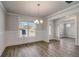 Dining room with wainscoting, wood floors, modern light fixture, and natural light at 3870 Ivy Cottage Dr, Snellville, GA 30039