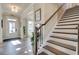 Beautiful entryway featuring hardwood floors, natural light, and an adjacent staircase at 3870 Ivy Cottage Dr, Snellville, GA 30039
