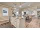 Stylish kitchen island with granite countertops and a view of the open concept living space at 3870 Ivy Cottage Dr, Snellville, GA 30039